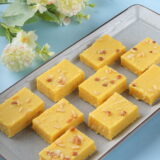 buy "Enjoy within the powerful charm of Patisa, a cherished Indian sweet known for its delicate layers of gram flour and ghee, enriched with a hint of cardamom and decorated with almonds. Each bite offers a perfect balance of sweetness and texture, making it a favorite during celebrations and special events.