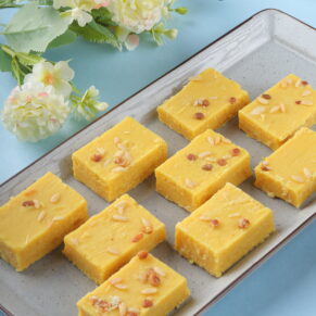 buy "Enjoy within the powerful charm of Patisa, a cherished Indian sweet known for its delicate layers of gram flour and ghee, enriched with a hint of cardamom and decorated with almonds. Each bite offers a perfect balance of sweetness and texture, making it a favorite during celebrations and special events.