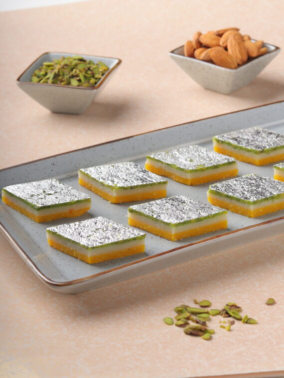 Badam Tiranga, a layered Indian sweet with almonds, colored in orange, white, and green.